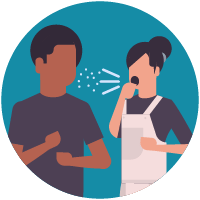 A woman sneezing while standing near a man